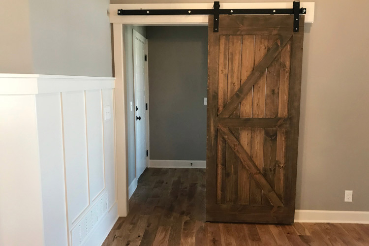 Barn doors can instantly transform a laundry room from a cold space to a warm