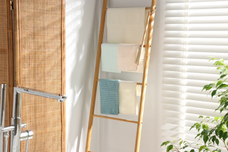 towel rack made from a leaning wood ladder is just so much better