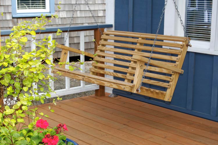 a porch swing brings the nostalgia of the farmhouse aesthetic