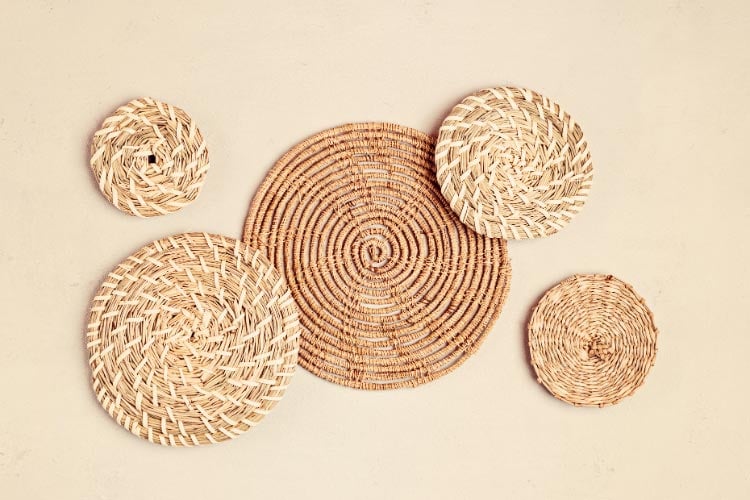 Incorporate natural fibers and geometric patterns with subtle holiday motifs into woven wall hangings