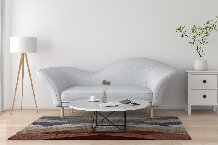 Place a rug under your seating arrangement to create a defined zone that makes your small living room feel more intentional and cohesive