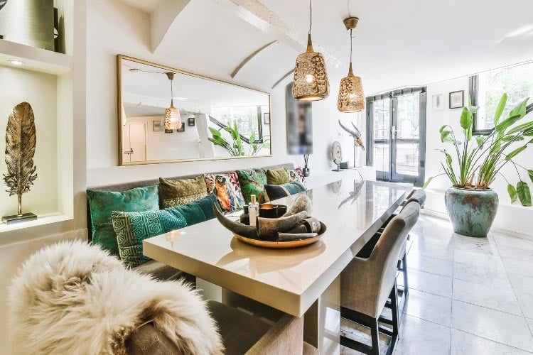 A farmhouse table with a concrete top and wooden base creates a bold and contemporary countryside look